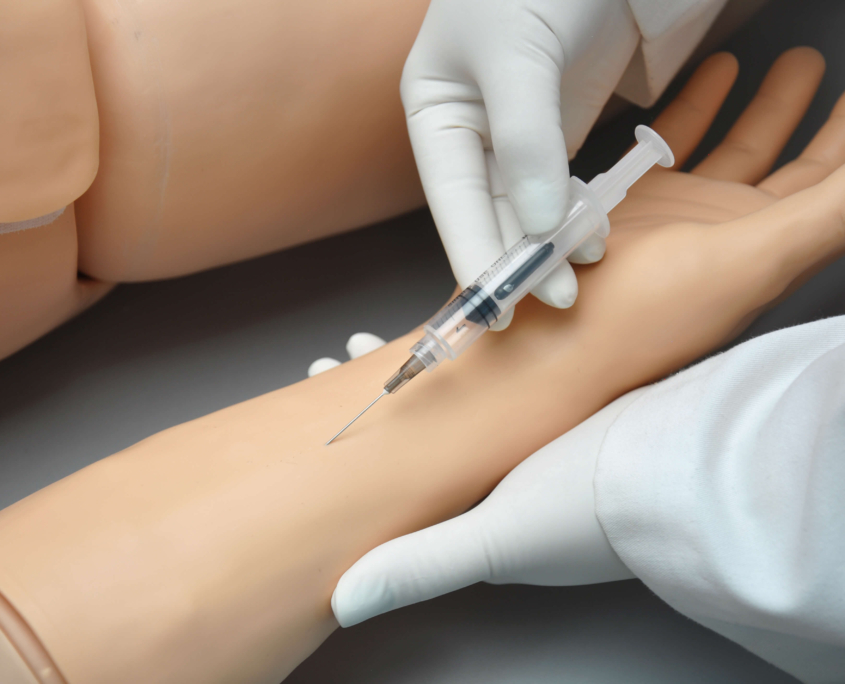 Gaumard-HAL-3201-drug-recognition-galerie Person setzt Spritze in Vene am Arm von Simulatorspuppe