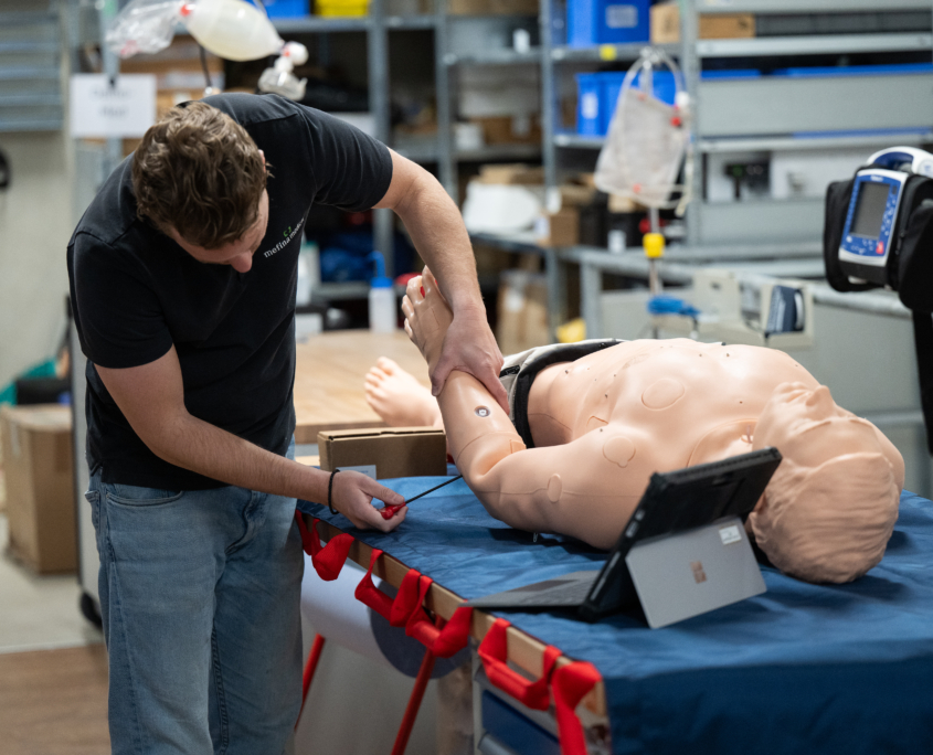 Mefina medical staff member repairing a patient simulator.